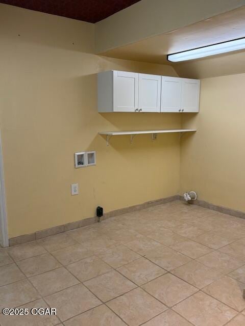 clothes washing area with washer hookup, baseboards, and light tile patterned floors