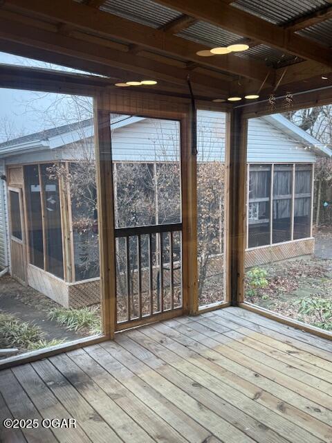 unfurnished sunroom with plenty of natural light