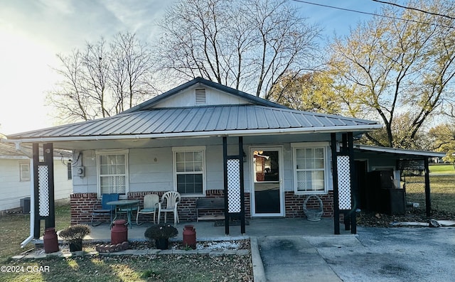 view of front of house with central AC unit and a porch