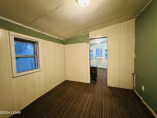 empty room featuring vaulted ceiling