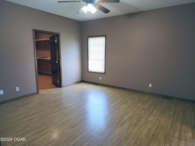 unfurnished room with wood-type flooring and ceiling fan