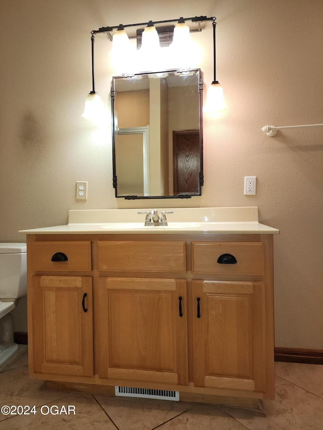 bathroom with vanity, toilet, and tile patterned floors