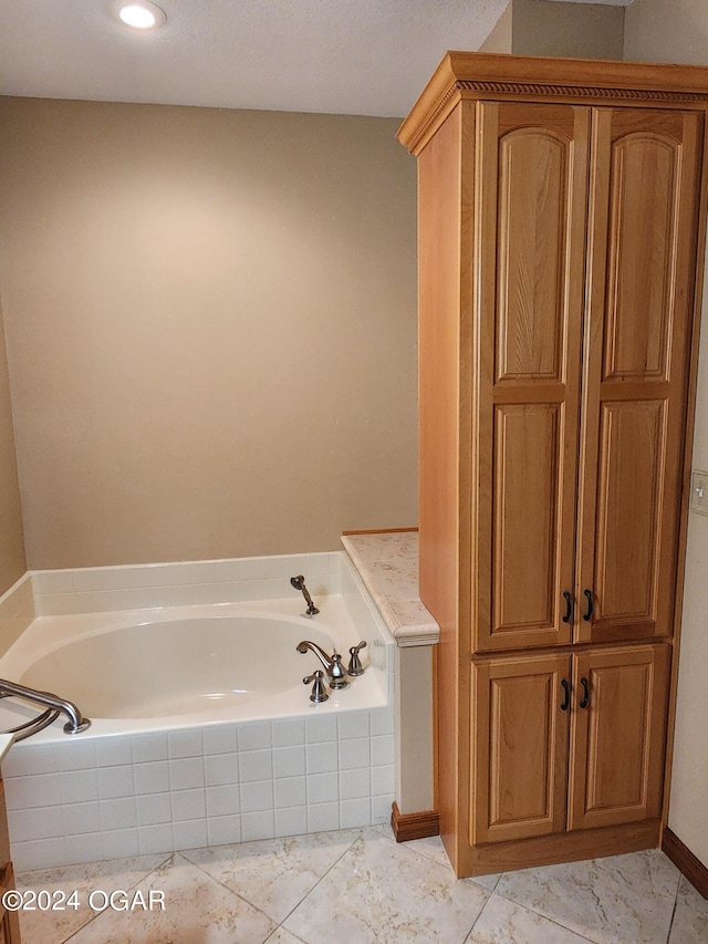 bathroom featuring tiled bath and tile patterned flooring