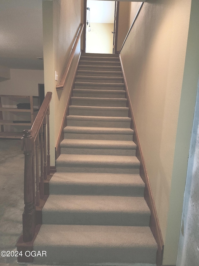 stairs featuring carpet