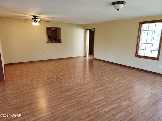 empty room featuring light wood-type flooring and ceiling fan