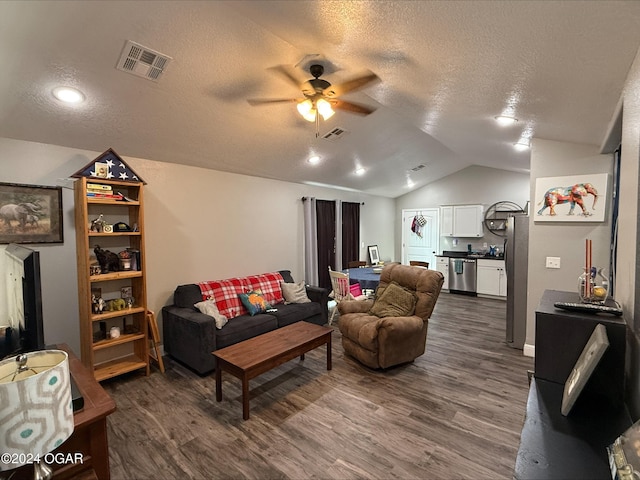 living room featuring a textured ceiling, dark hardwood / wood-style flooring, ceiling fan, and vaulted ceiling