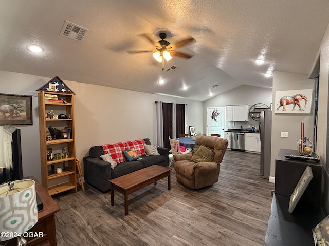 living room featuring dark hardwood / wood-style flooring, ceiling fan, a textured ceiling, and lofted ceiling