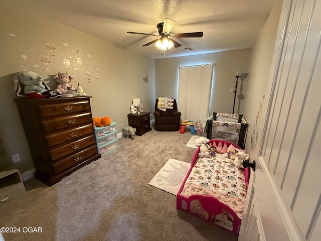 bedroom featuring ceiling fan, a textured ceiling, and carpet floors