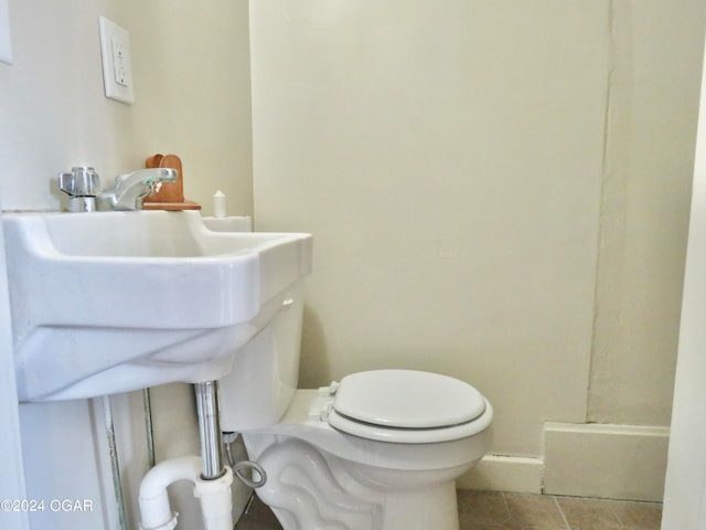 bathroom featuring toilet and tile patterned flooring