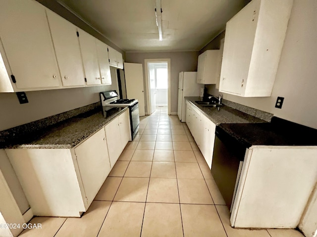 kitchen featuring light tile patterned flooring, track lighting, dark stone countertops, white appliances, and white cabinets