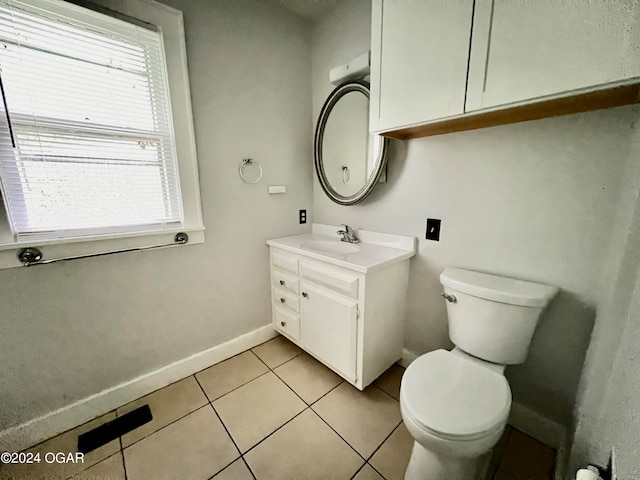 bathroom featuring vanity, tile patterned flooring, and toilet