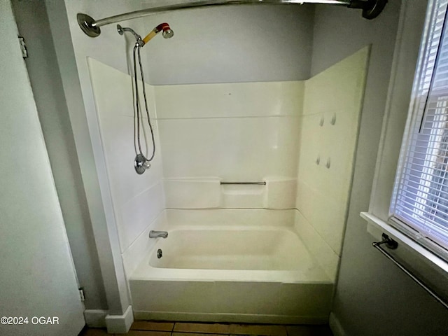 bathroom featuring tile patterned flooring and washtub / shower combination