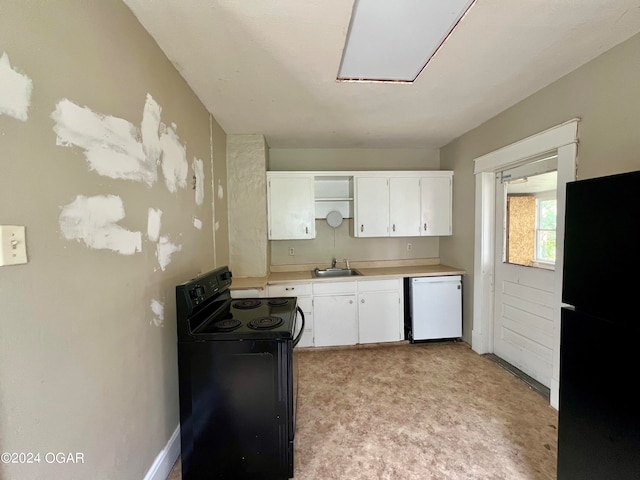 kitchen featuring white cabinets, light colored carpet, black appliances, and sink