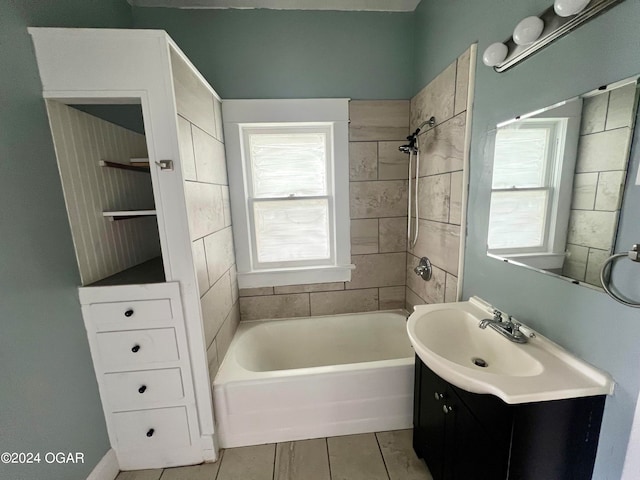 bathroom featuring vanity and tiled shower / bath