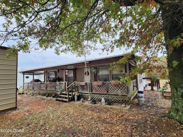 back of property featuring a porch