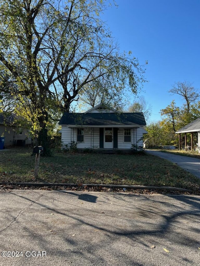 bungalow-style house with a front yard