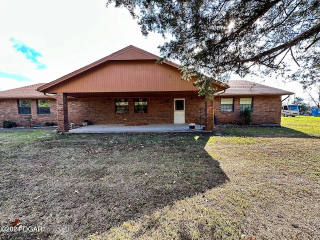 rear view of house featuring a yard and a patio