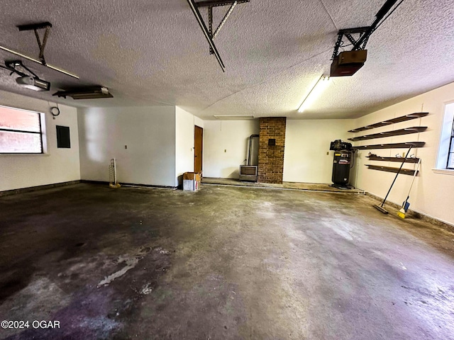 garage with electric panel and a garage door opener