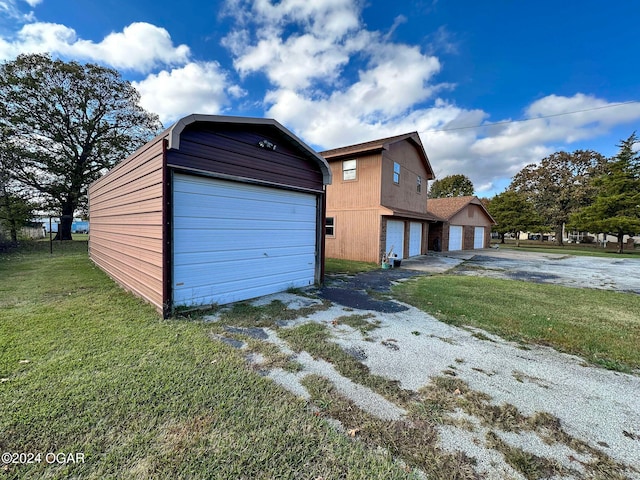 garage featuring a lawn