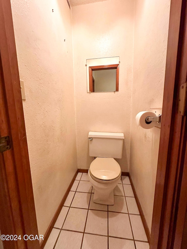 bathroom featuring toilet and tile patterned floors