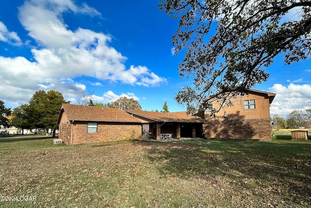 rear view of house with a lawn