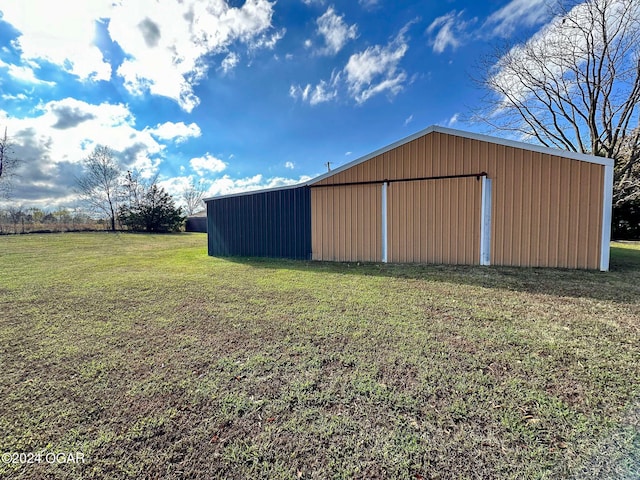 view of outbuilding with a yard