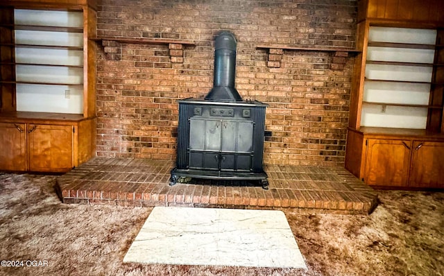 room details featuring carpet flooring and a wood stove