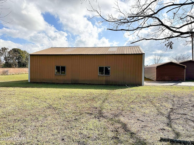 view of outbuilding featuring a yard