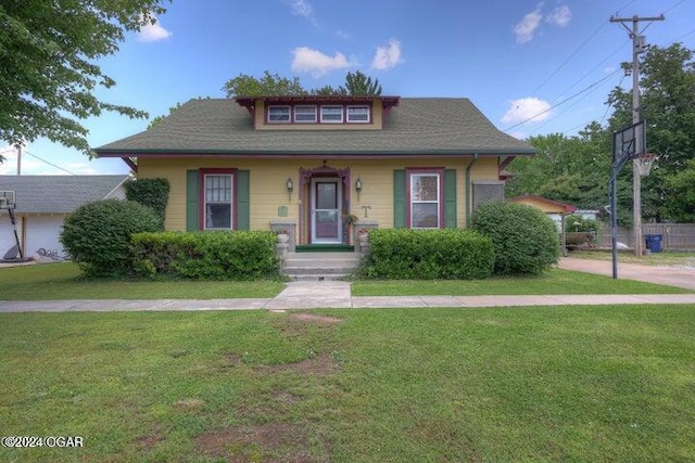 bungalow-style house with a front lawn