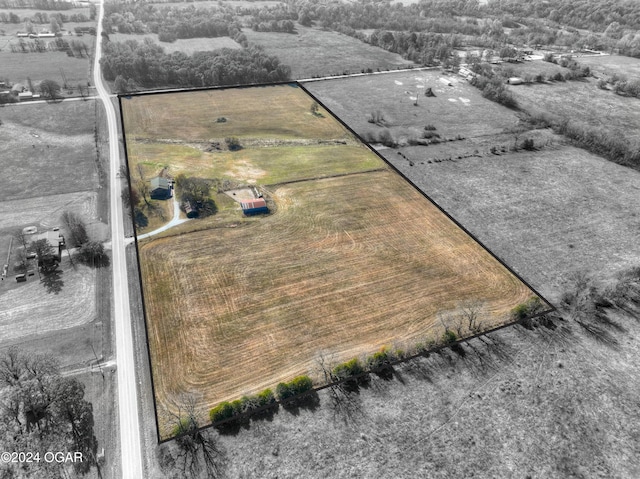 birds eye view of property with a rural view