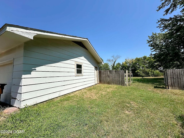 view of side of home featuring a lawn