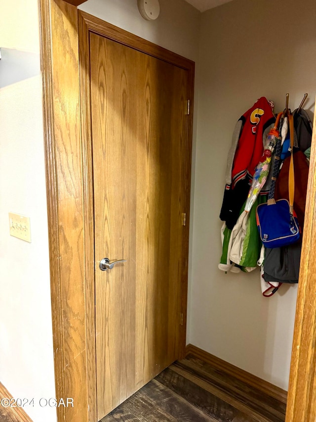 hallway with dark hardwood / wood-style flooring