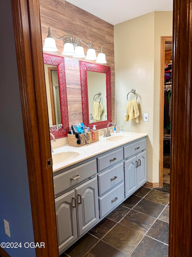 bathroom with vanity and wooden walls