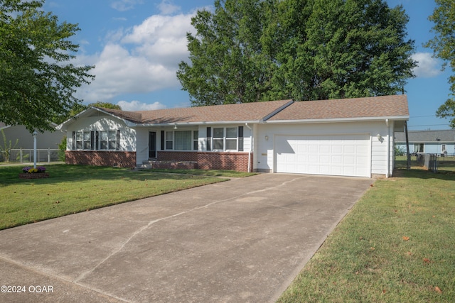 ranch-style home featuring a garage and a front lawn