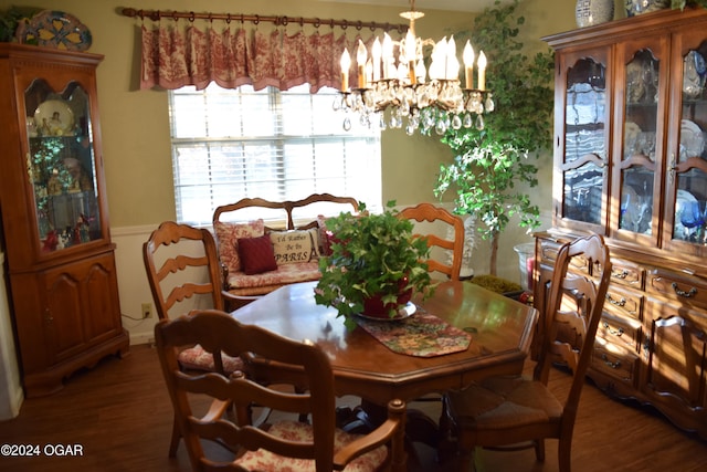 dining space with dark hardwood / wood-style flooring and a notable chandelier