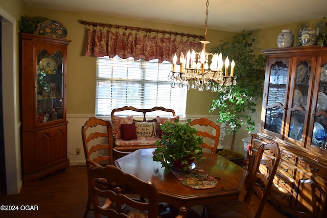 dining area featuring an inviting chandelier and dark wood-type flooring