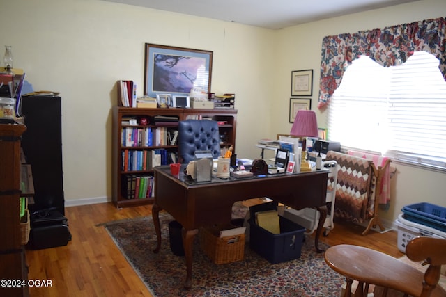 home office with wood-type flooring