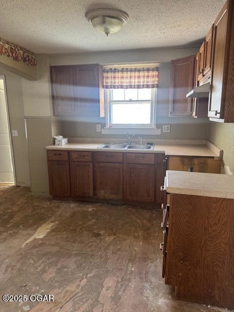 kitchen featuring sink and a textured ceiling