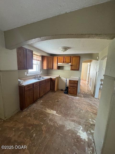 kitchen with sink and a textured ceiling