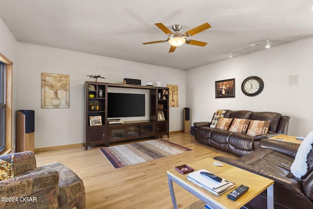 living room featuring light hardwood / wood-style floors and ceiling fan