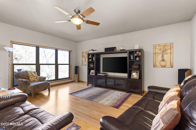 living room featuring light wood-type flooring and ceiling fan