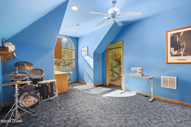 interior space featuring ceiling fan, lofted ceiling, and dark colored carpet