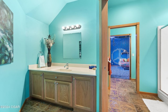 bathroom featuring vanity and lofted ceiling