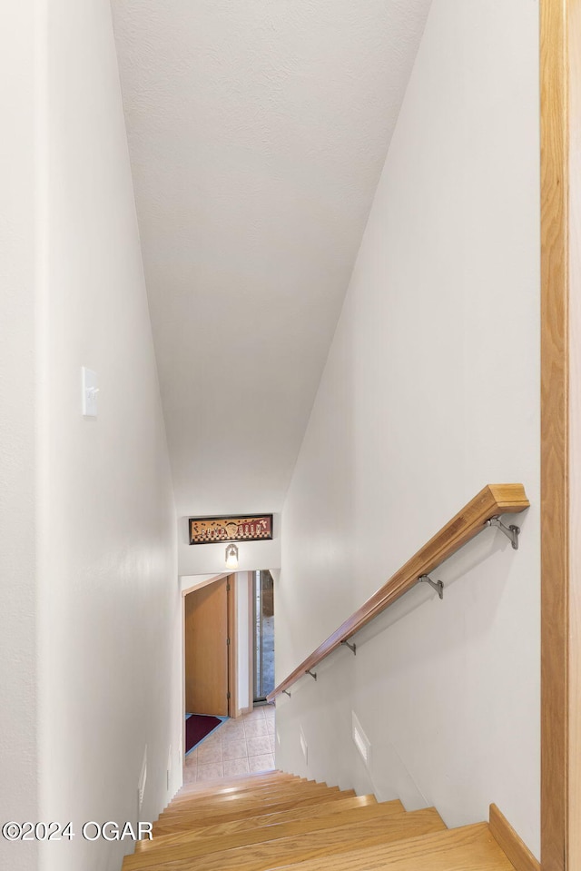 stairs featuring hardwood / wood-style floors