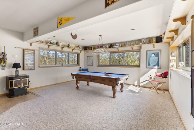 playroom featuring a wood stove, plenty of natural light, carpet floors, and pool table