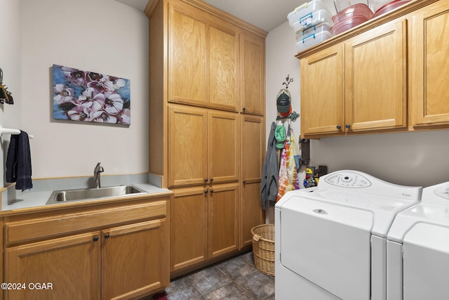 washroom featuring washer and clothes dryer, sink, and cabinets