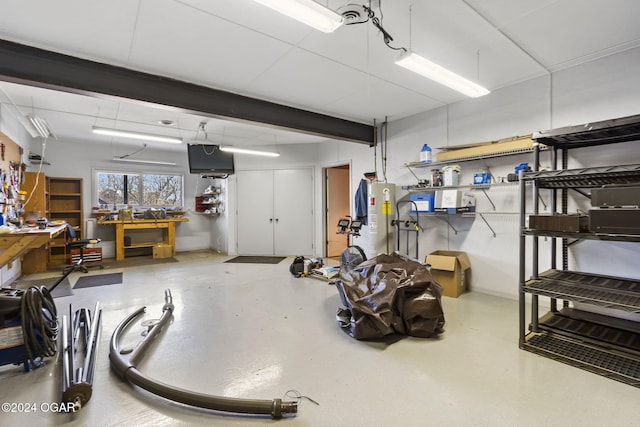 basement featuring a workshop area and water heater