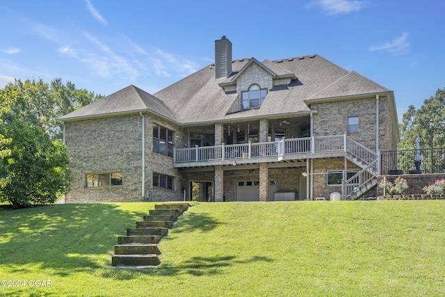 back of property featuring a lawn, a garage, and a wooden deck