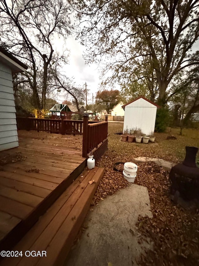 view of yard with a storage unit and a deck