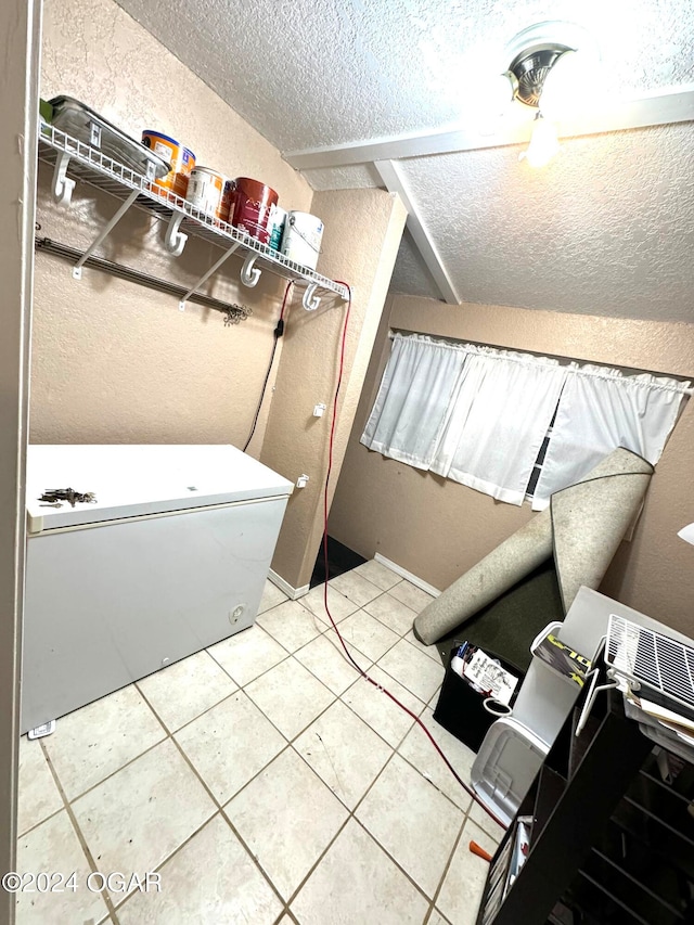 bathroom with tile patterned floors and a textured ceiling